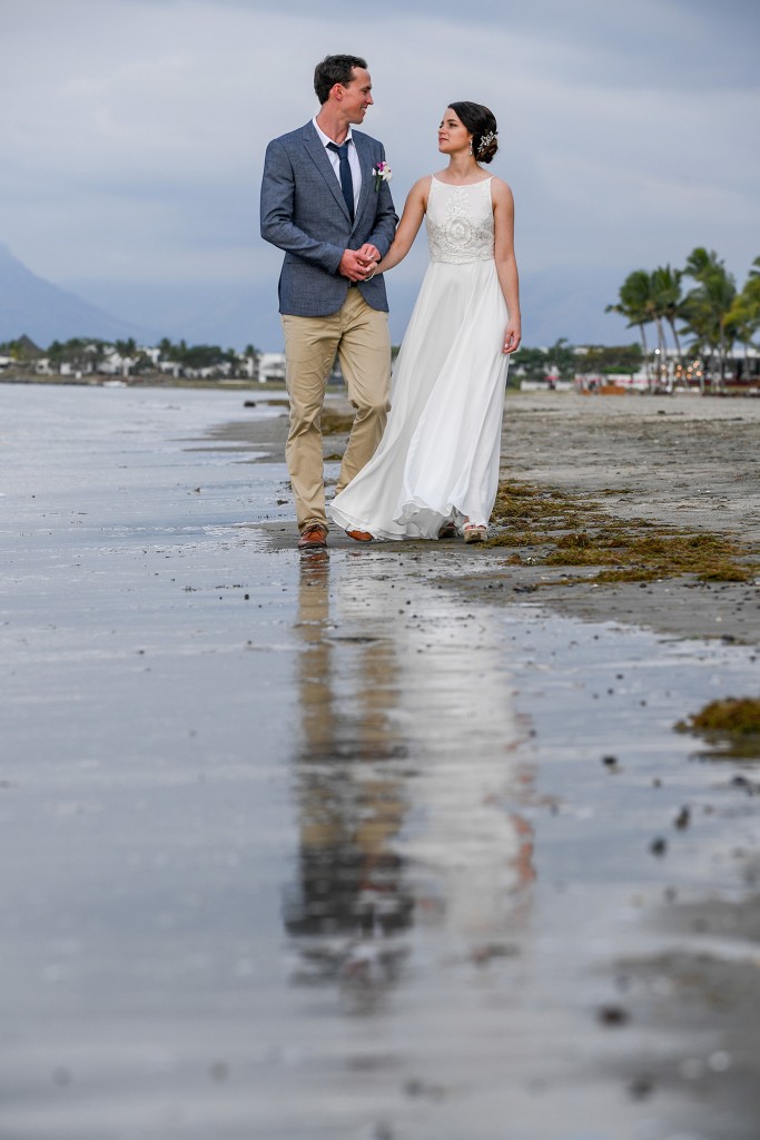 The sea reflects the newly weds strolling on the beach at Denarau Fiji