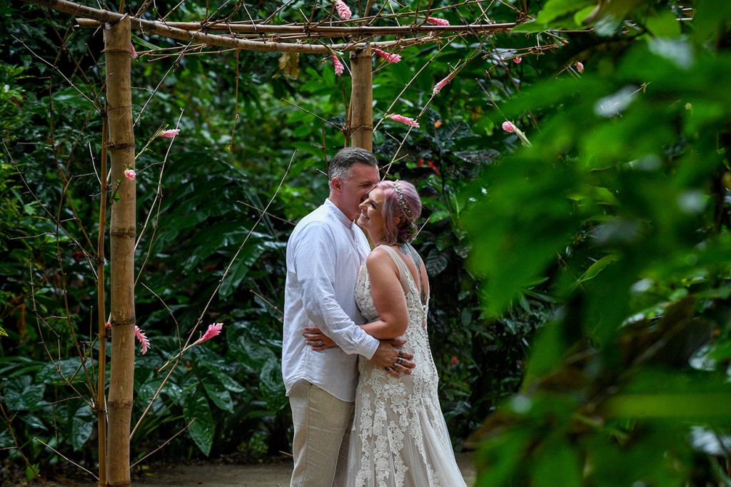 The newly weds have an intimate moment in the tropical rain forest