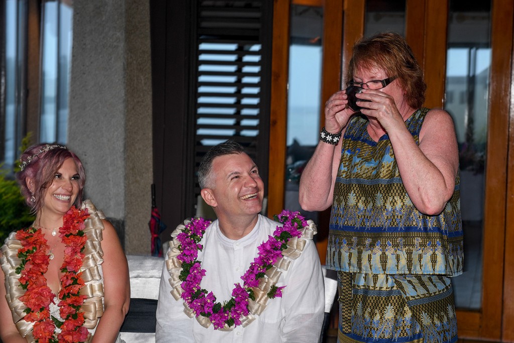 The groom smiles as he watches his mother drink the traditional Fiji tea