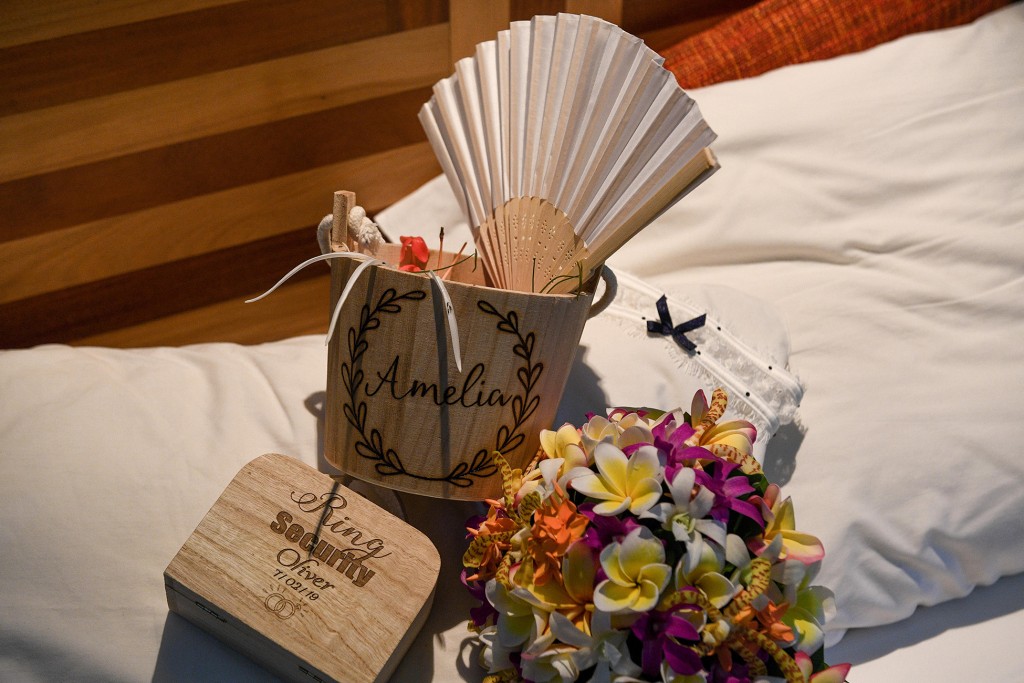 A customized wooden fan embroidered in the bride's name