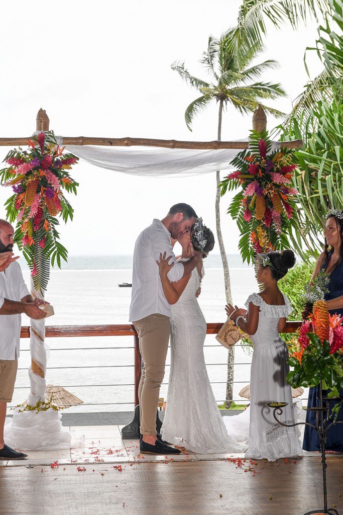 The newly weds share a passionate kiss at their beach altar at Warwick Fiji