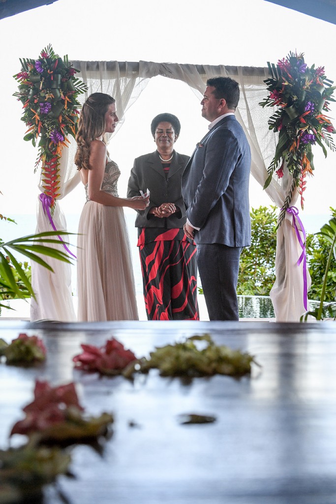 The couple stand at the traditional Fiji altar overlooking the Pacific