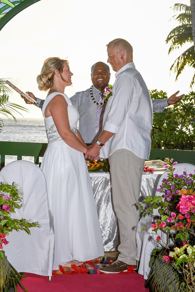 The celebrant happily pronounces the couple as man and wife against a stunning sunset