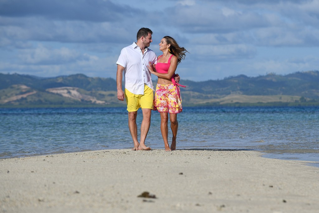 The couple strolls on the beige beaches of Nadi Fiji