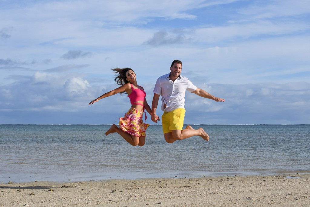 The couple leaps into the air on the beach at Nadi Fiji