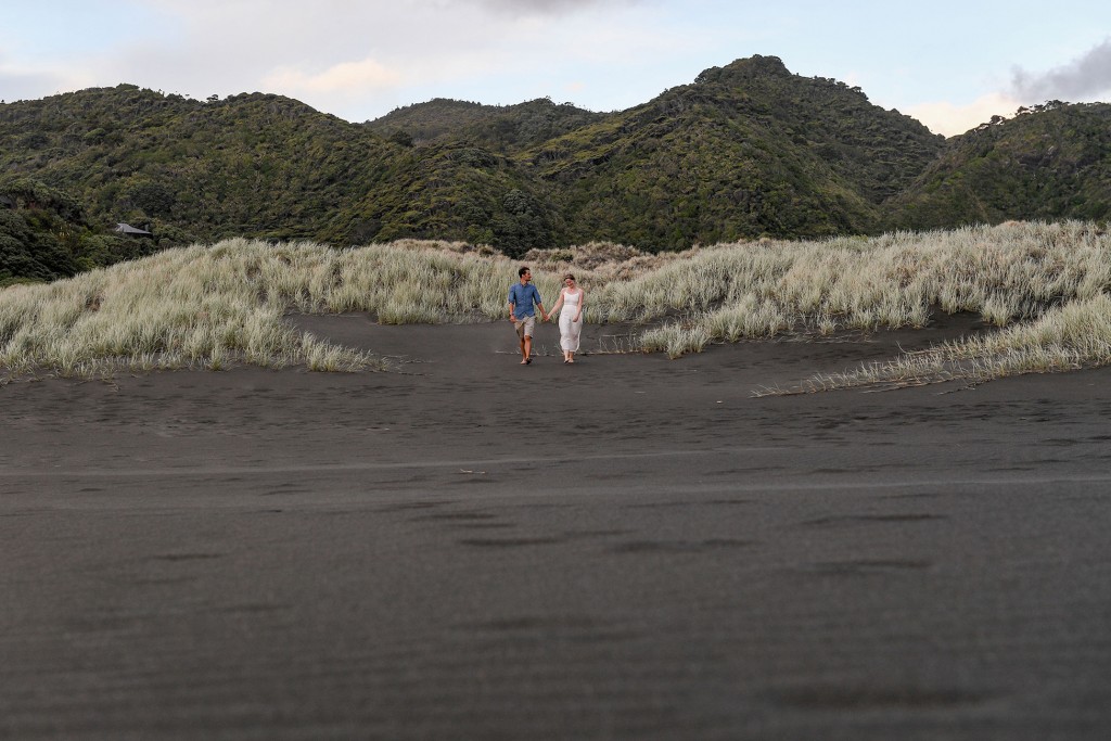 The newly weds stroll on black sand beaches
