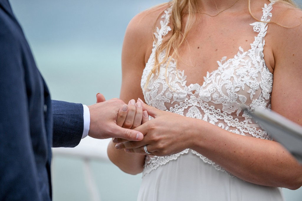 Closeup of the married couple hand in hand
