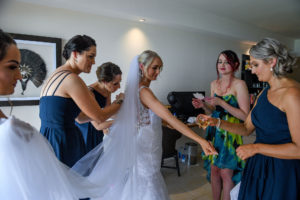 The bride shows off her stunning wedding gown to the bridesmaids