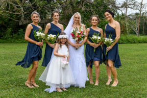 The bride poses with her bridesmaids and flower girls