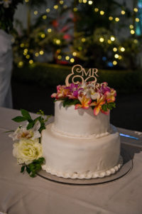 wedding cake topped with fiji flowers