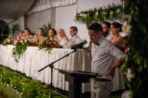 The groom's brother reads a speech at the wedding reception