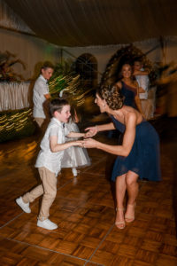 One of the bridesmaids dances with the best boy at the wedding reception