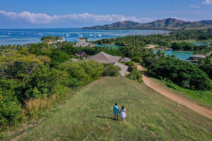 A drone shot of the couple staring at the landscape view of Malolo Island Fiji