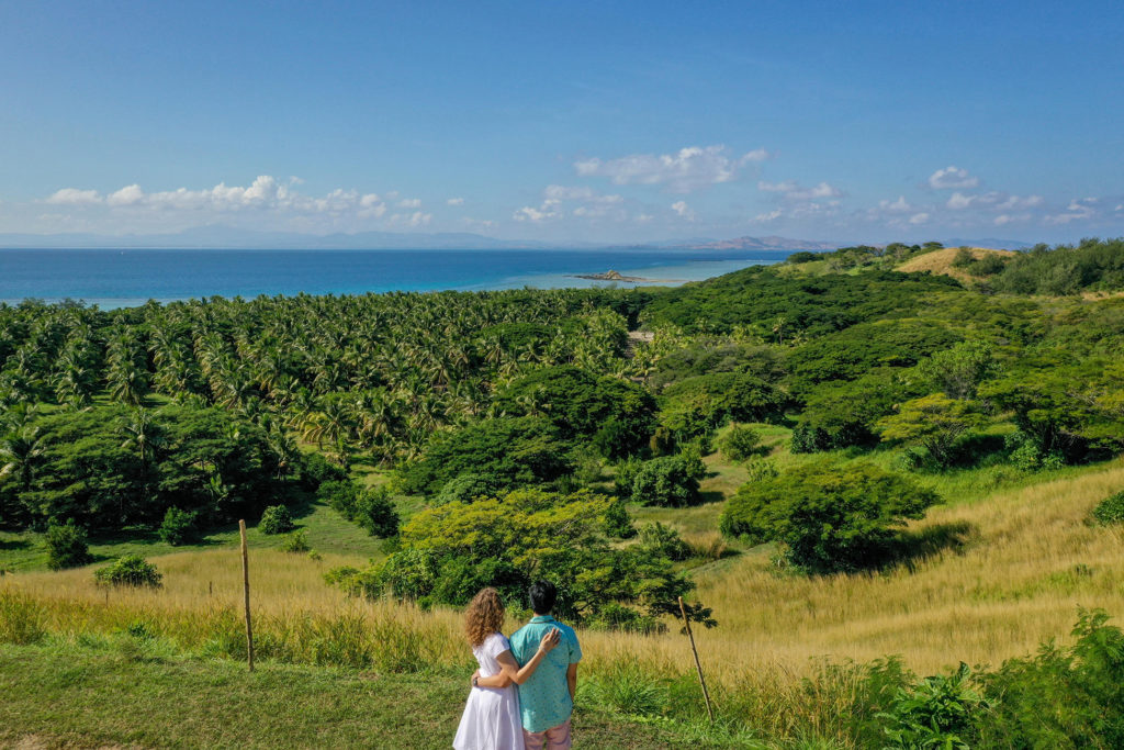 The loving couple stares into the rolling green hills of Malolo Island