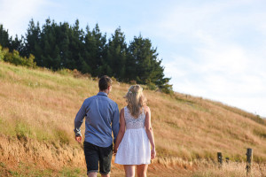 The engaged couple hand in hand Summer Engagement photo shoot in the country Pukekokhe Auckland Photographer Anais Chaine