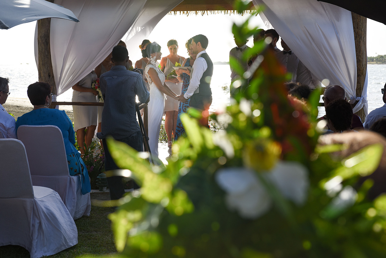 Composition with flowers blurred in the foreground and the ceremony in the background