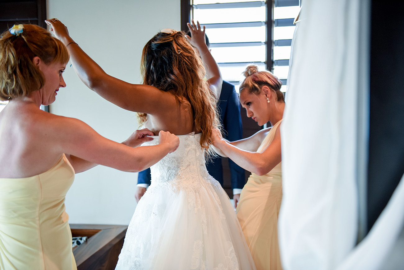 the last adjustment on the bride's wedding dress At Paradise Cove Island resort in the Yasawas, Fiji
