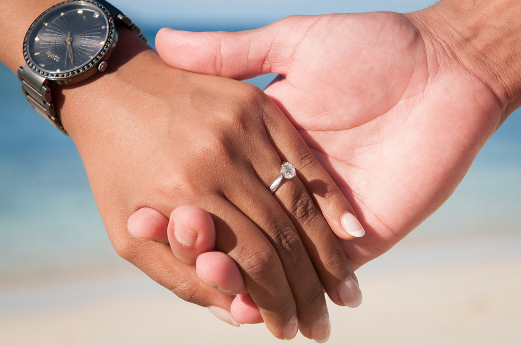 Couple holding hands with engagement ring and a big diamond at Mana Island resort, Fiji by Anais Photography
