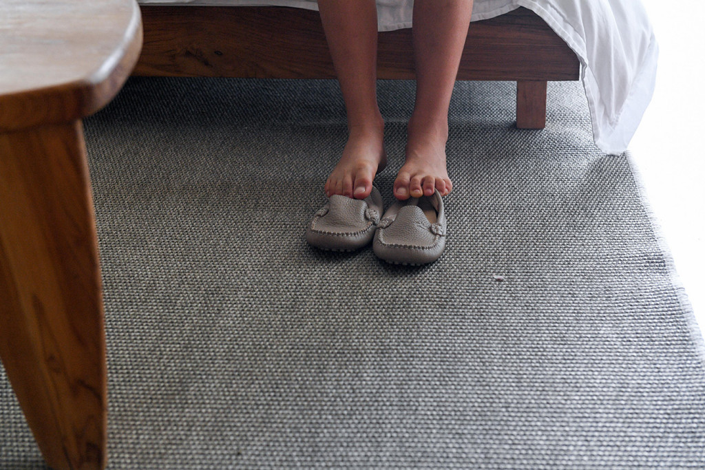 Detail of the son'ts feet and his shoes at Vomo Island resort, Fiji
