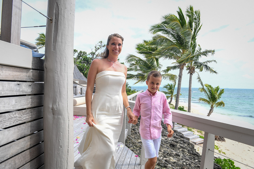 Mother holding her son's hand and walking to the ceremony at Vomo Island resort, Fiji