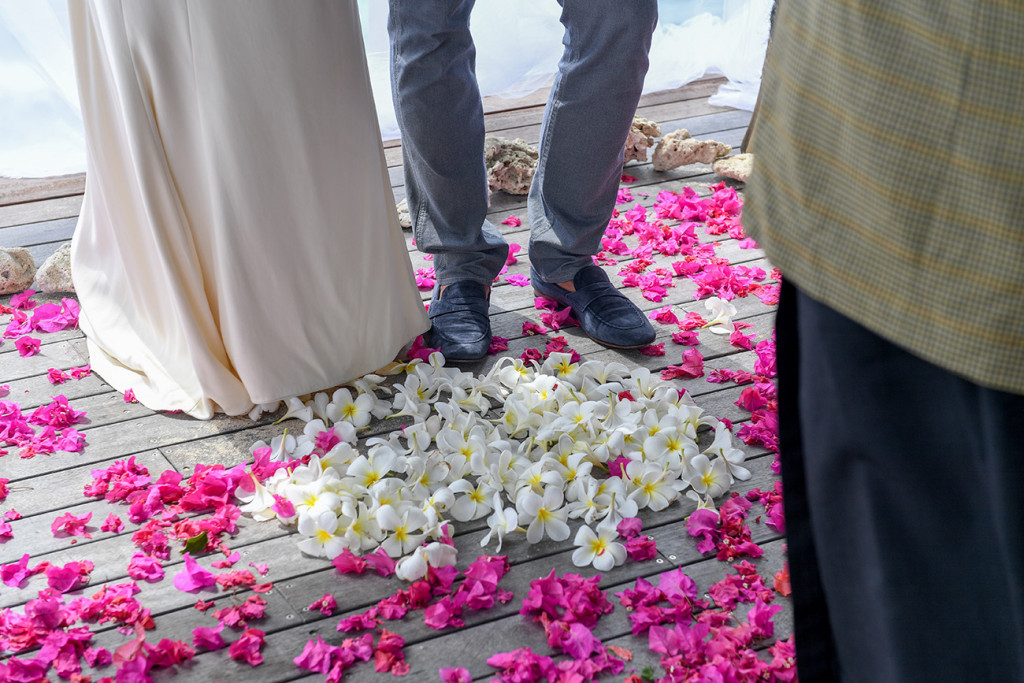 Tropical Fijian flowers on the floor in the shape of a heart with the couple in the middle at their 10 years wedding anniversary at Vomo Island resort, Fiji