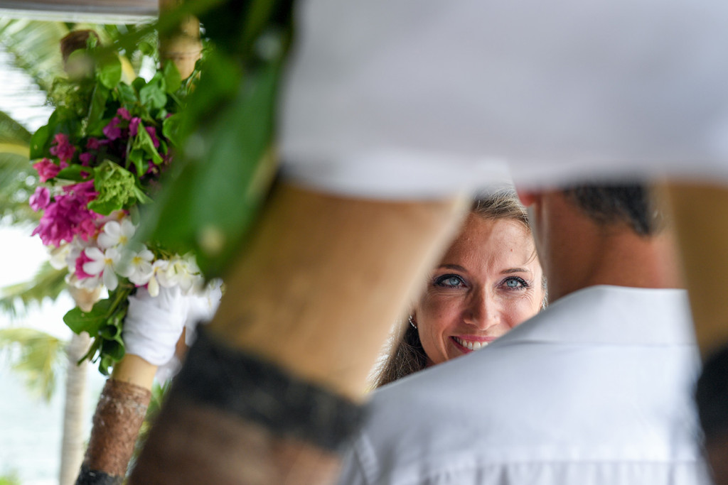 Wife is looking at her husband smiling during the ceremony at Vomo Island resort, Fiji