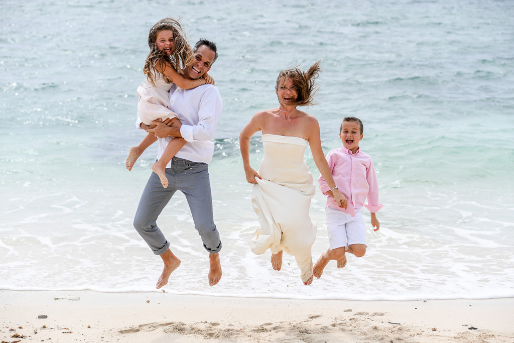 Family jumping by the beach at Vomo Island resort, Fiji