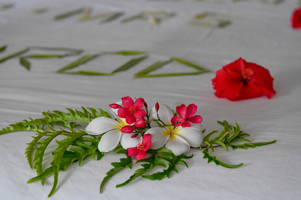 Frangipane flowers on the bed at Vomo Island resort, Fiji