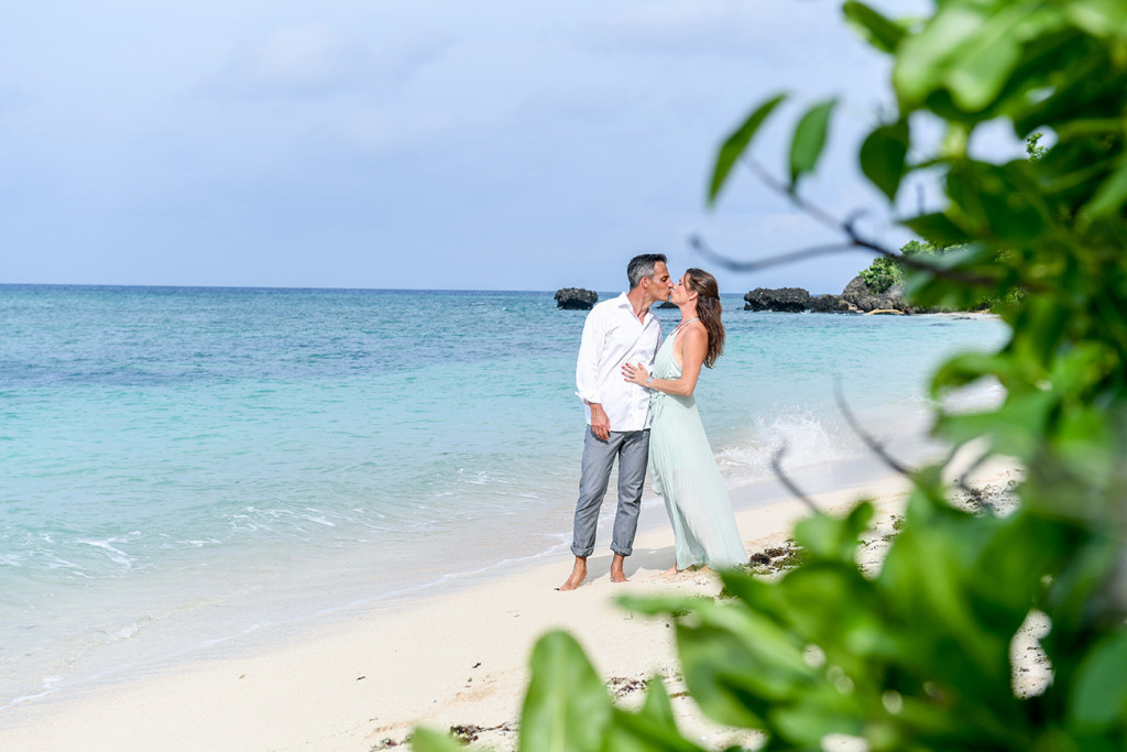 Couple kissing on the beach at Vomo Island resort, Fiji
