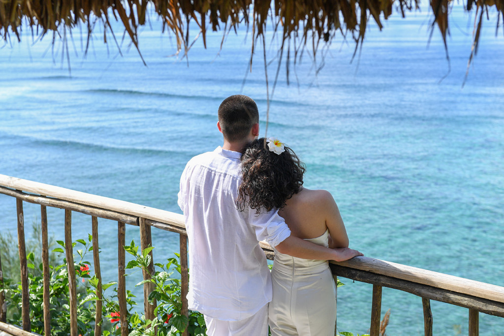 The couple at Sunset point with blue sea Paradise Cove island resort, Fiji
