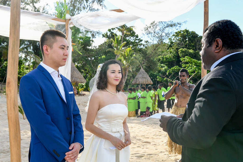 The couple say yes I do at the wedding ceremony by the beach at Paradise cove island resort, Yasawas, Fiji