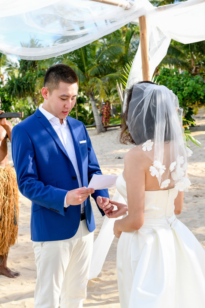 The groom is telling the bride his vows at Paradise cove island resort, Yasawas, Fiji