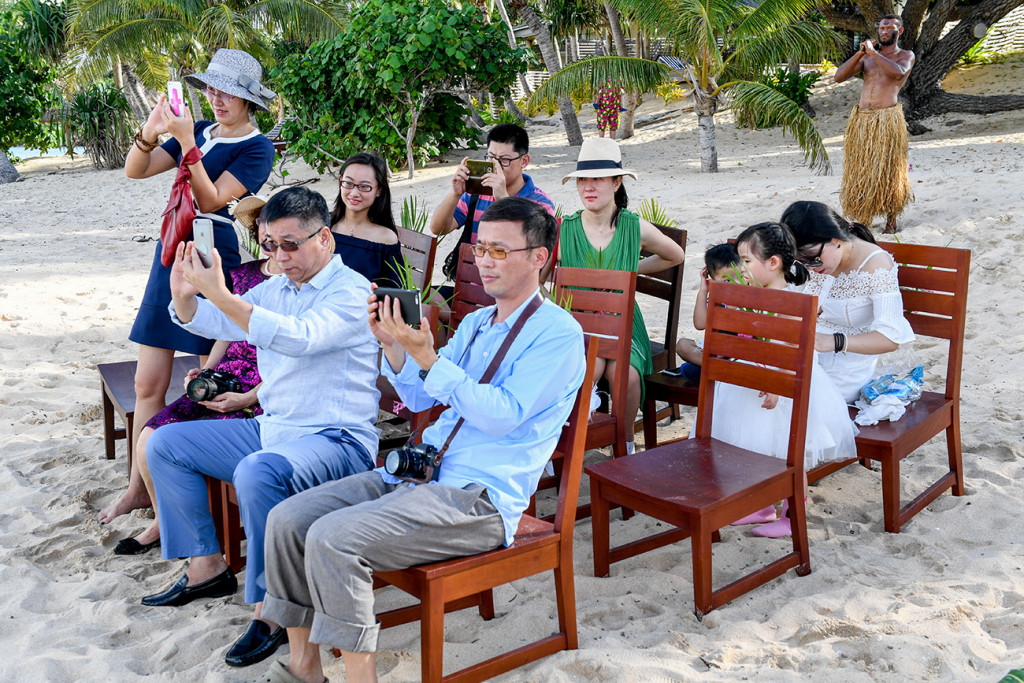 The guests are taking photos during the wedding ceremony at Paradise cove island resort, Yasawas, Fiji