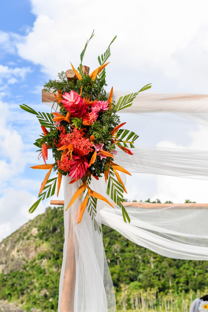 Tropical Fijian flowers are decorating the wooden structure at the wedding ceremony at Paradise cove island resort, Yasawas, Fiji