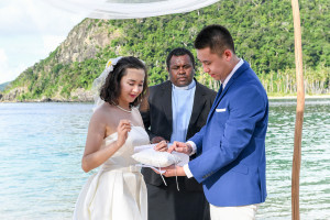 The bride is taking the ring on the illow at Paradise cove island resort, Yasawas, Fiji