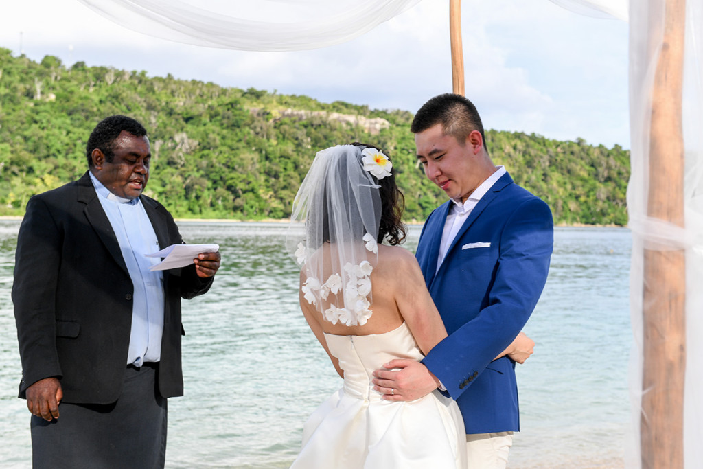 The husband and wife are hugging at Paradise cove island resort, Yasawas, Fiji