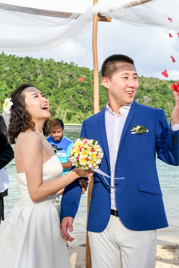 Petals are flying above the husband and wife after their wedding ceremony at Paradise cove island resort, Yasawas, Fiji