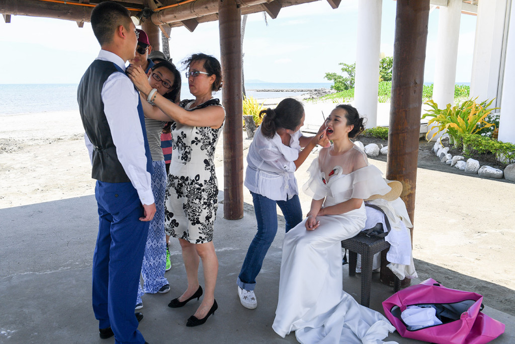 the groom is getting ready for his photography by the sheraton beach in Denerau, Fiji