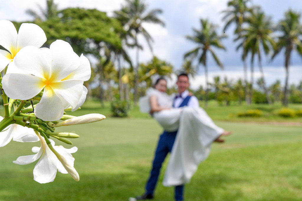The groom is carrying the bride at the golf course in Denerau, Nadi Fiji.