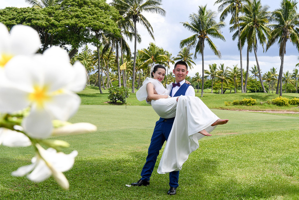 The groom is carrying his wife at the golf course in Denerau, Nadi Fiji.