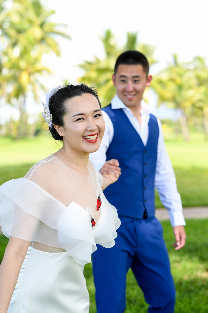 Portrait of the bride while her husband is pulling her in the back at the golf course in Denerau, Nadi Fiji.