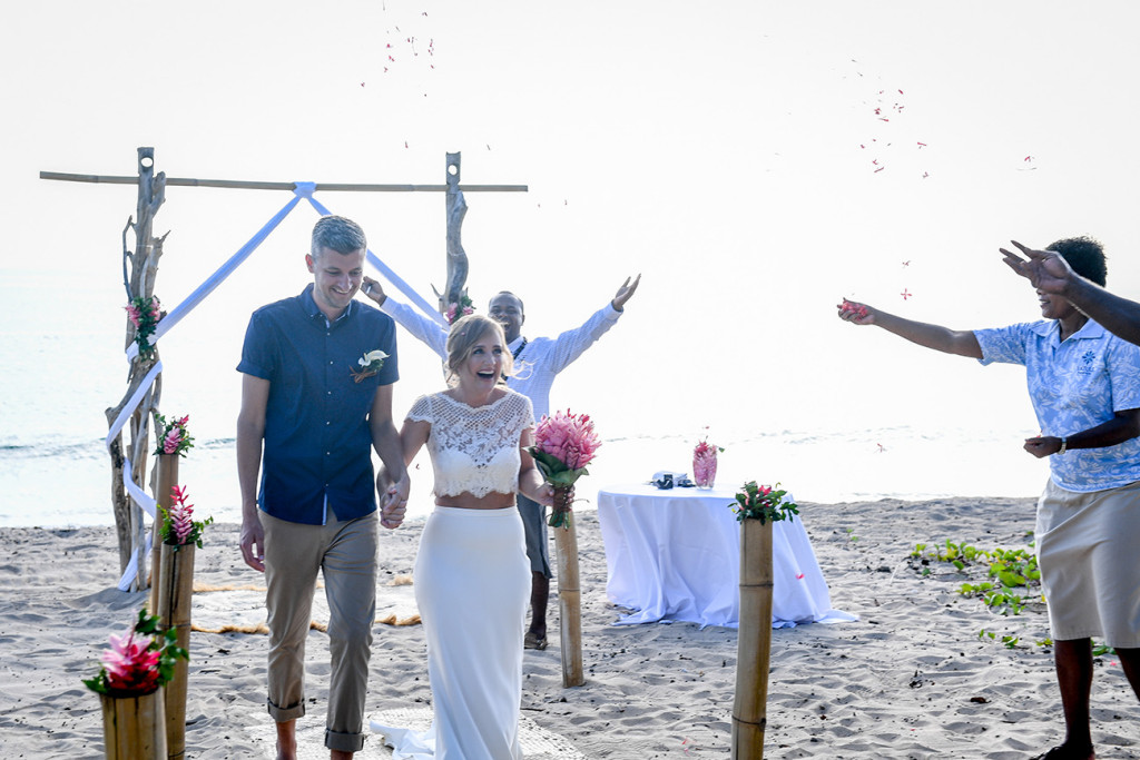 Bride and groom walk down aisle in Yatule Fiji Beach elopement
