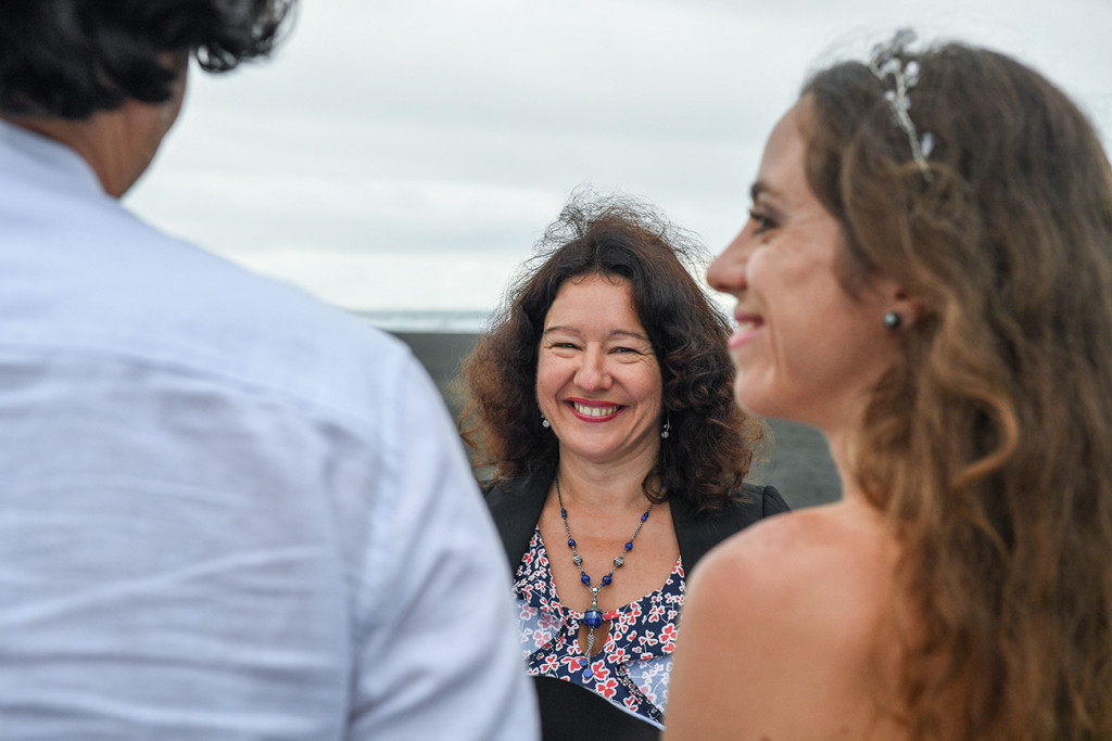 Cheerful celebrant officiates elopement wedding in Karekare Auckland NZ
