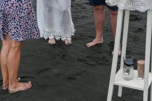 Eloped couple feet in black sand beach of Karekare Auckland New Zealand