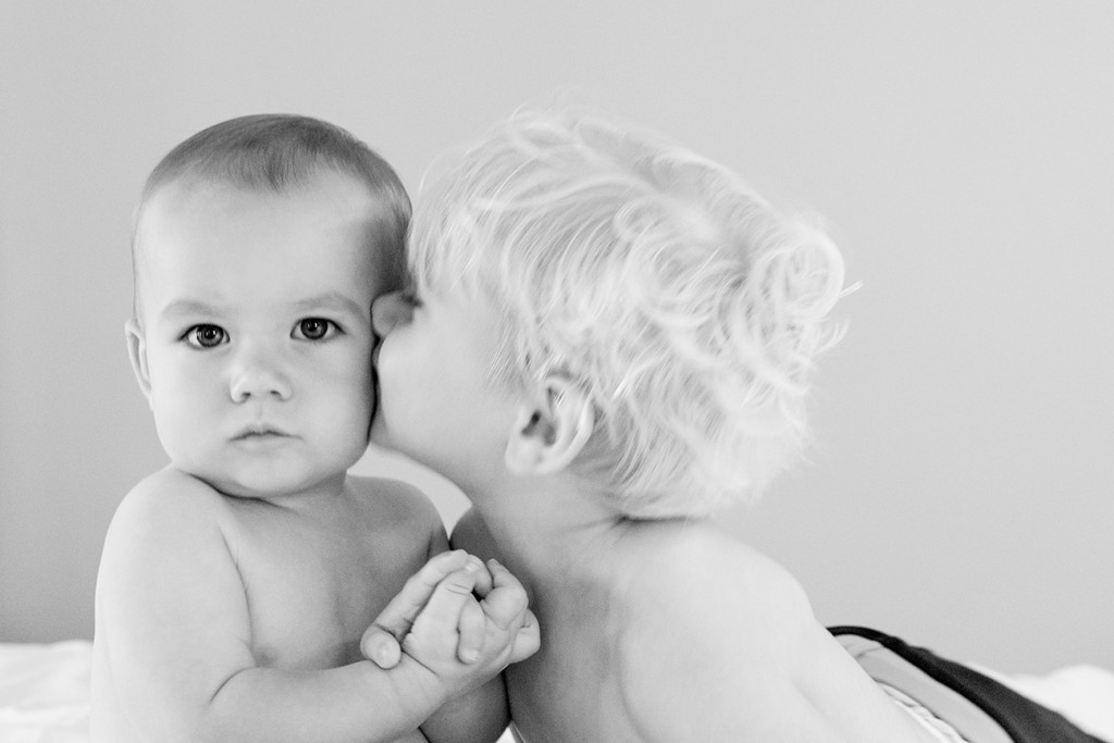 Cute black and white babies kiss before Vomo Resort Fiji wedding