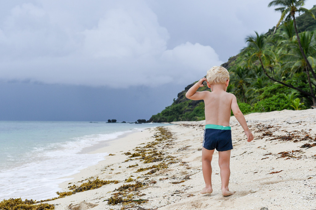 Baby walks down the beach of Vomo Island Resort Fiji