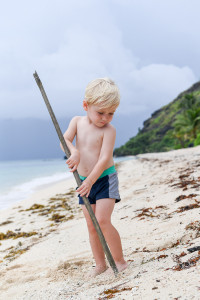 Young boy plays on Vomo Resort Beach at family Fiji wedding