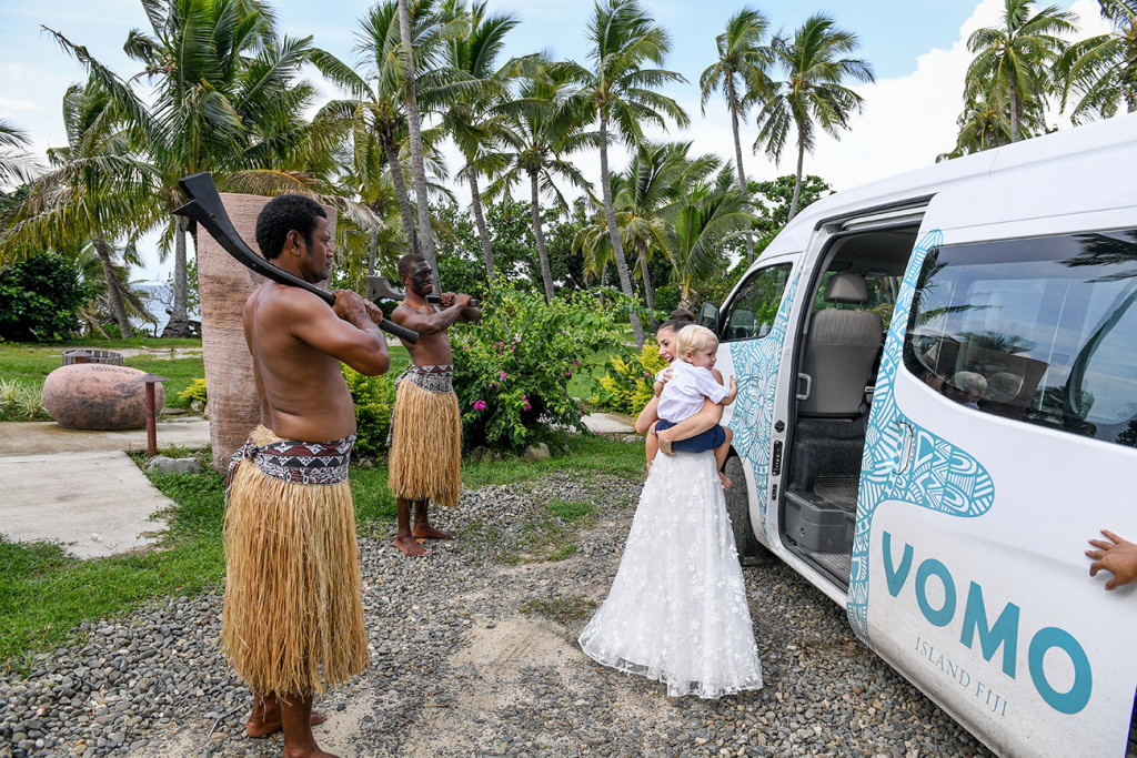 Traditional Fiji warrior look on as bride leaves Vomo Island Resort Fiji