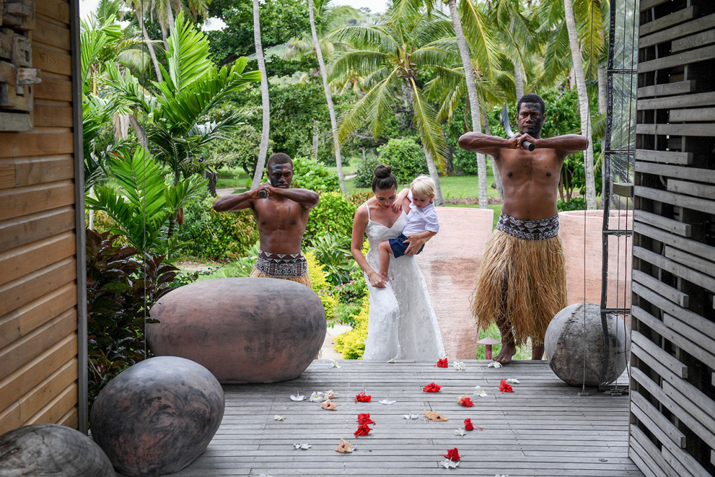 Traditional Fijian warriors watch as bride walks down the aisle.