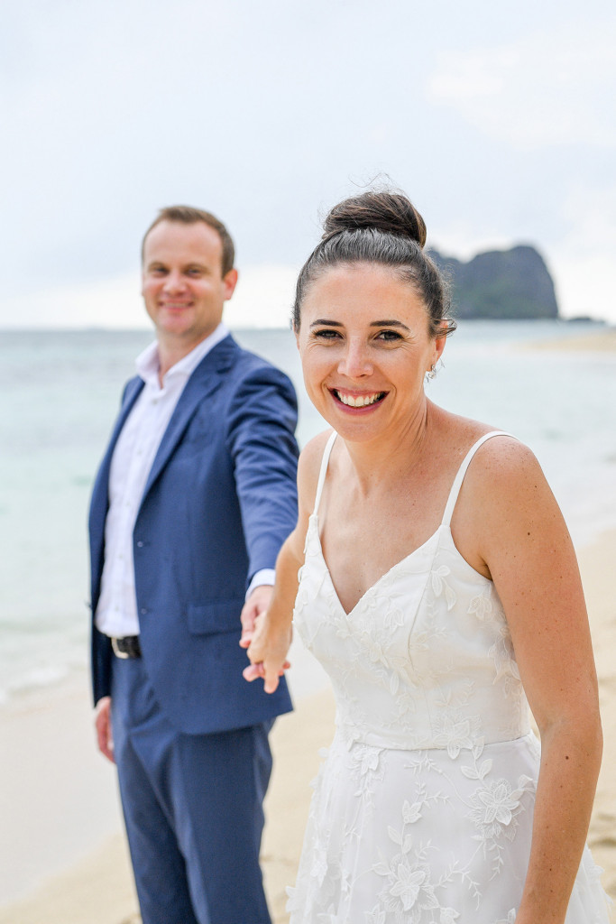 Bride pulling groom in Vomo Island Resort Fiji wedding
